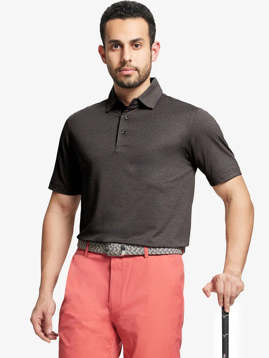 Front half-body shot of model holding golf club wearing Ventilated Heather Jacquard Polo – DARK BROWN HEATHER