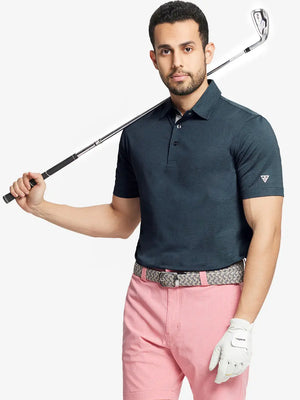 Front half-body shot of model holding golf club wearing Ventilated Heather Jacquard Polo – JUNGLE GREEN HEATHER