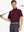 Model holding golf club in a half-body front pose wearing BURGUNDY HEATHER Cool Heather Texture Polo
