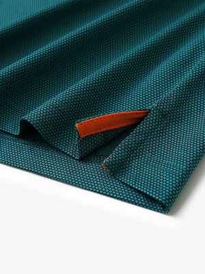 Detail shot of hem slit on TURQUOISE Performance Ananas Jacquard Polo