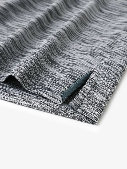 Close-up of the hem slit design in BLACK GREY HEATHER Cool Heather Texture Polo