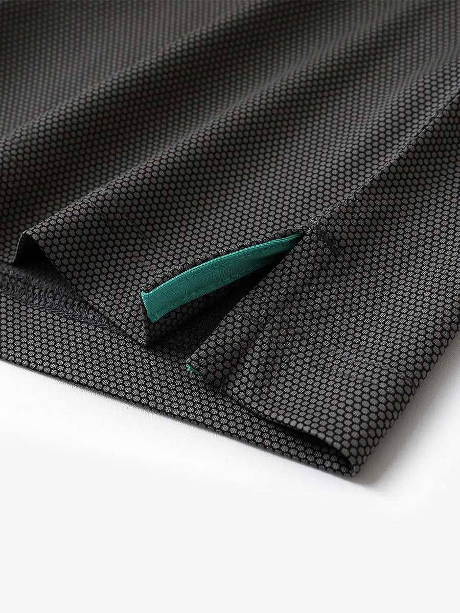 Close-up of side hem slit detail on BLACK Performance Ananas Jacquard Polo