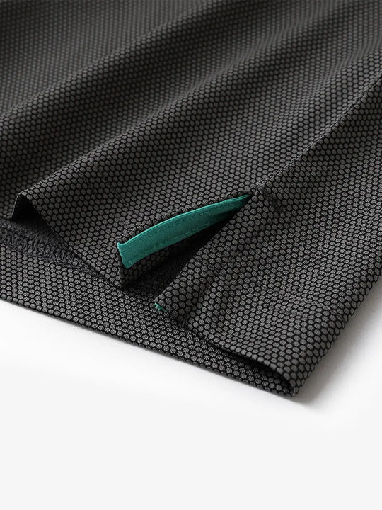 Close-up of side hem slit detail on BLACK Performance Ananas Jacquard Polo