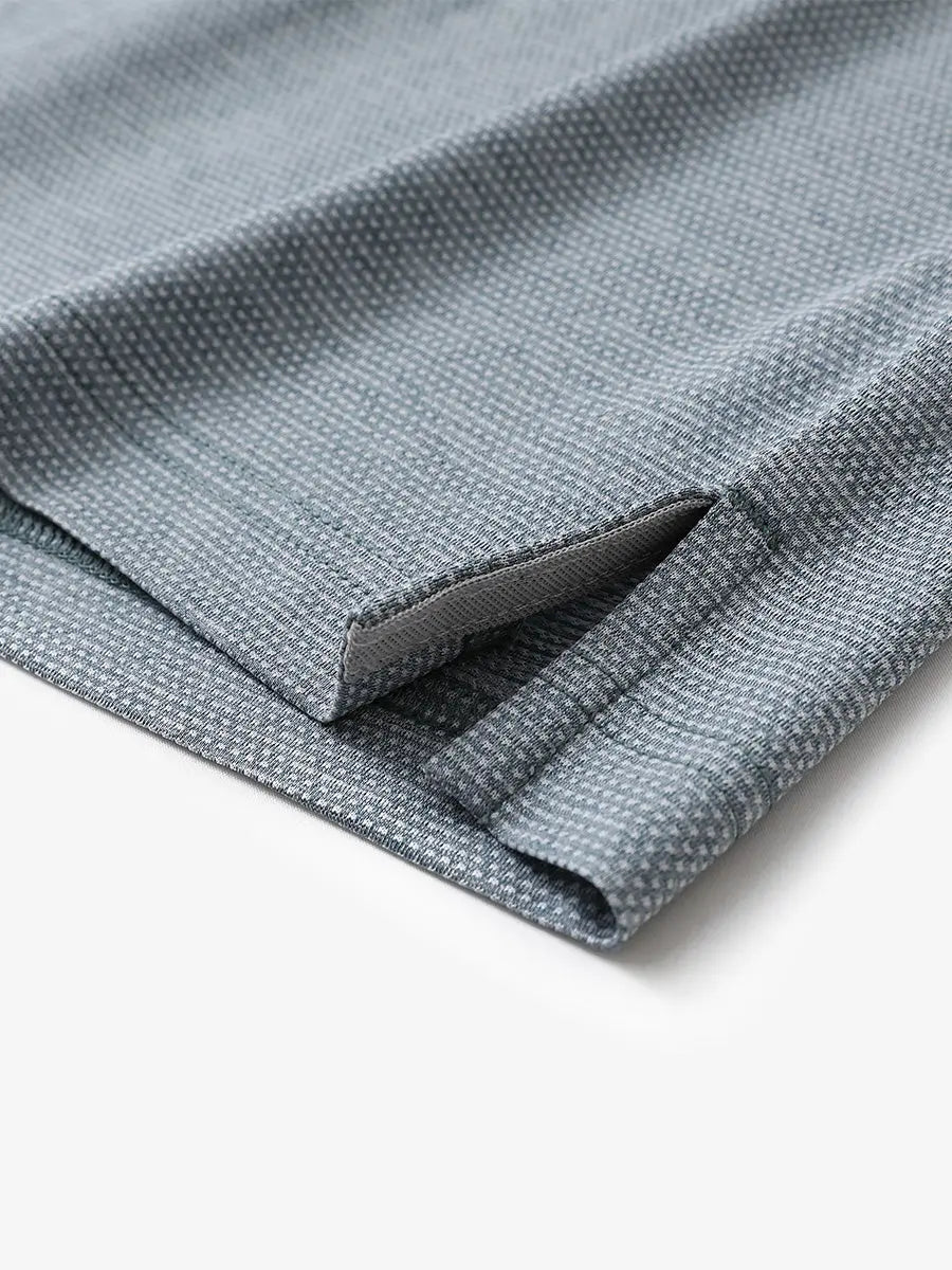 Hem slit detail close-up on SLATE GREEN HEATHER Ventilated Heather Jacquard Polo