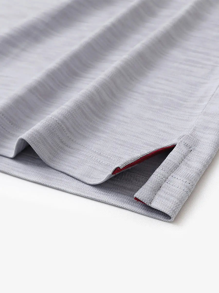 Hem slit detail close-up in FADED DENIM HEATHER Cool Heather Texture Polo