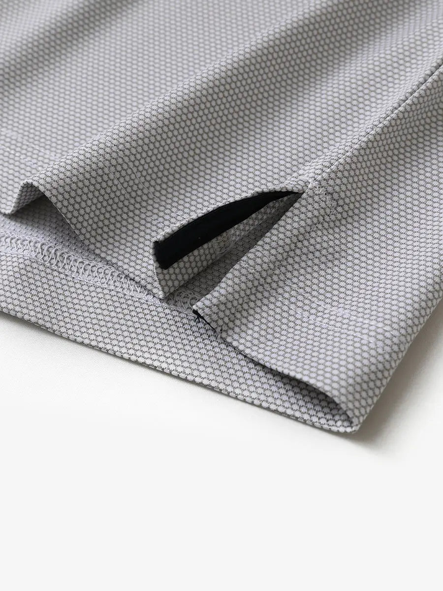 Close-up of side hem slit detail on GREY WHITE Performance Ananas Jacquard Polo