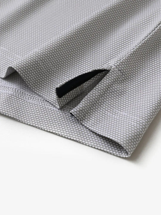 Close-up of side hem slit detail on GREY WHITE Performance Ananas Jacquard Polo