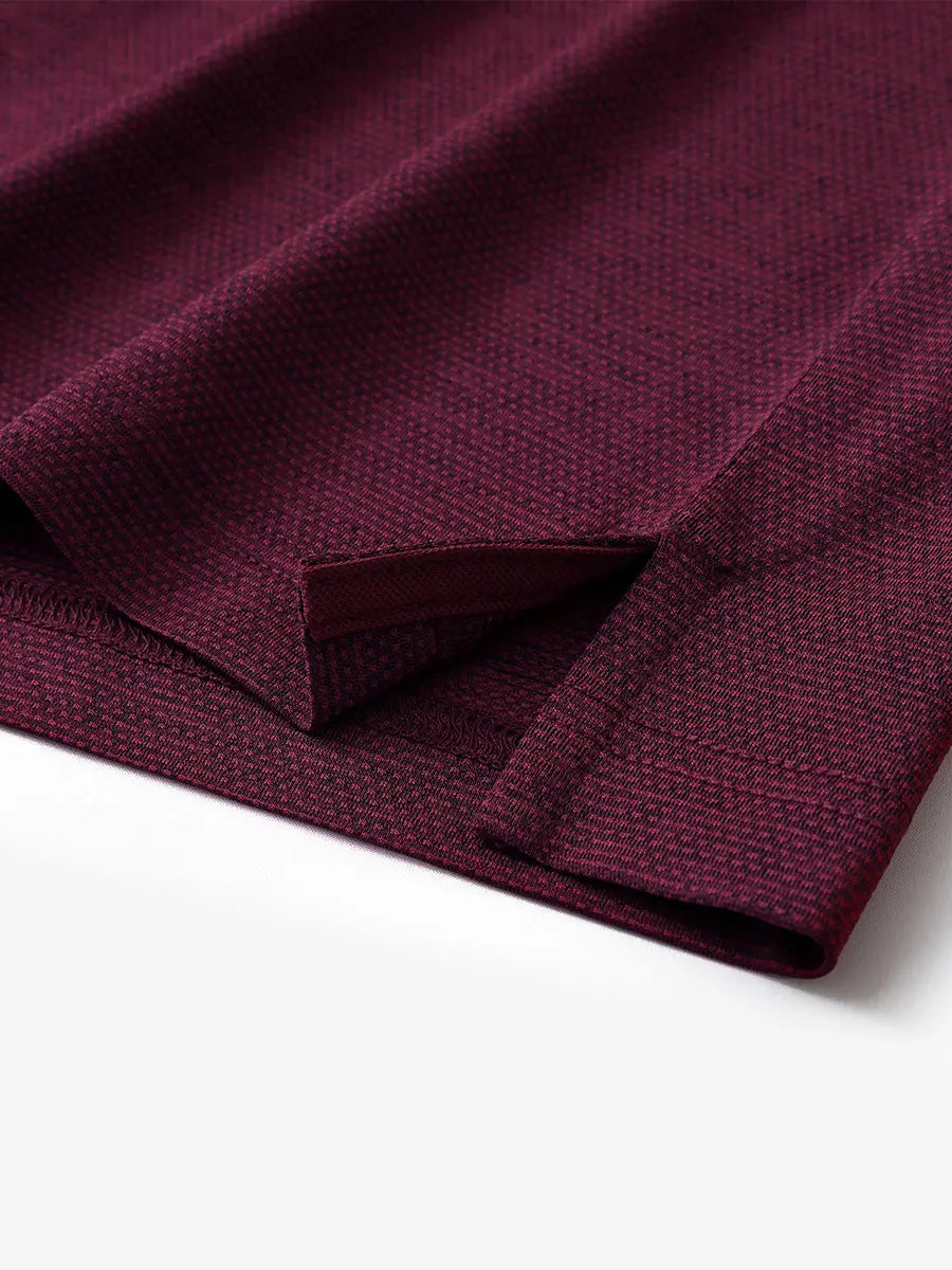 Close-up of side hem slit on Ventilated Heather Jacquard Polo in BURGUNDY HEATHER, showing detail