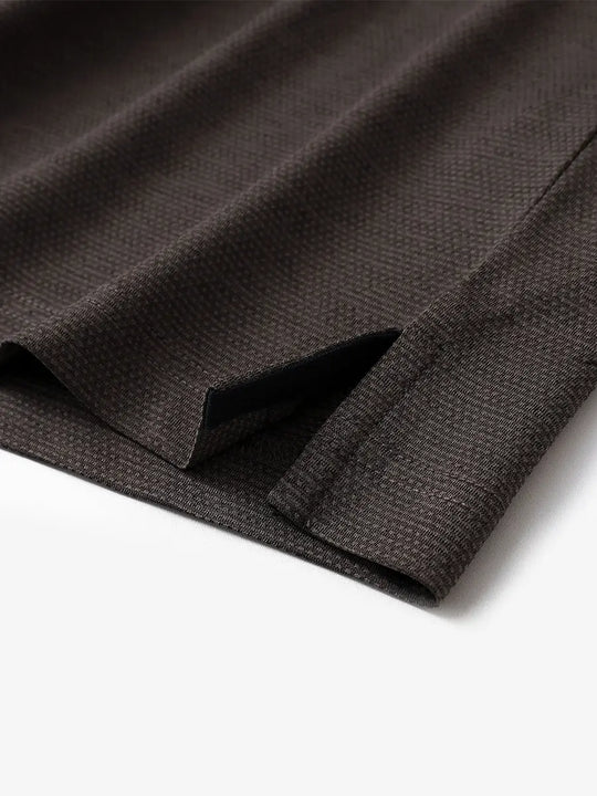 Close-up of side hem slit on Ventilated Heather Jacquard Polo in DARK BROWN HEATHER, showing detail