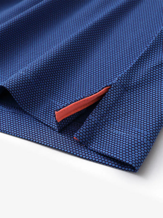 Close-up of side hem slit detail on PLUM BLUE Performance Ananas Jacquard Polo