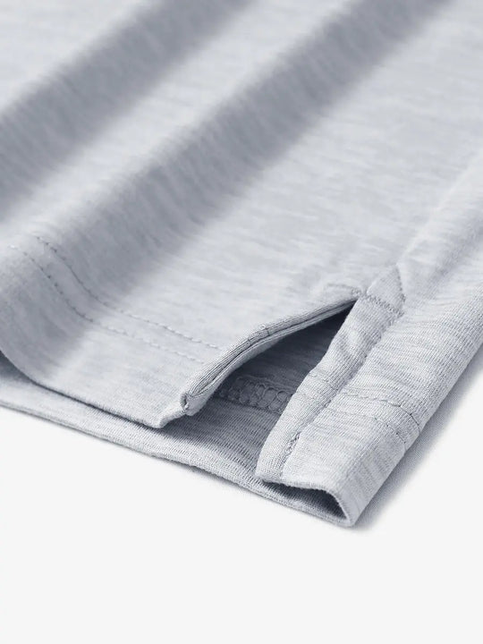 Faded Denim Heather Skin-friendly Long Sleeve Melange Polo – close-up detail of side hem slit