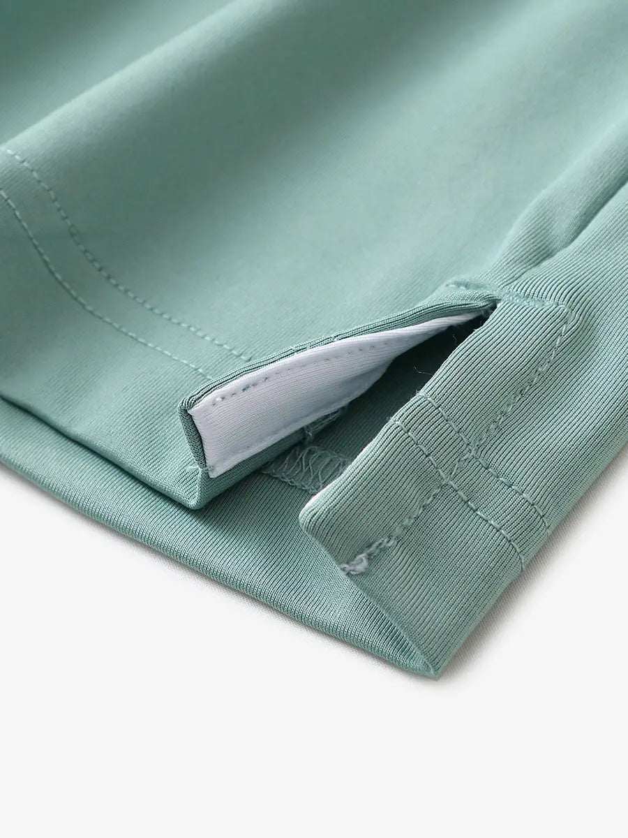 Close-up of hem slit detail in BERYL GREEN Premium Performance Polo