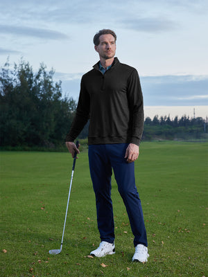 Model on grass under blue sky, leaning on golf club, wearing quarter zip melange pullover in black.