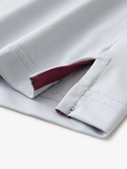Close-up of hem slit detail in GLACIER GREY Premium Performance Polo