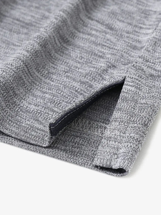 Close-up of hem opening on Modern Fit Melange Polo in GREY HEATHER, showcasing fine stitching and design.