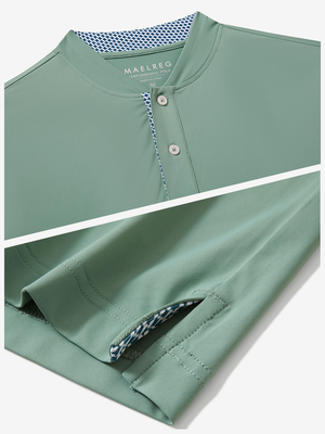 Detail of grey green moisture-wicking short sleeve henley shirt showing collar and hem vent construction.
