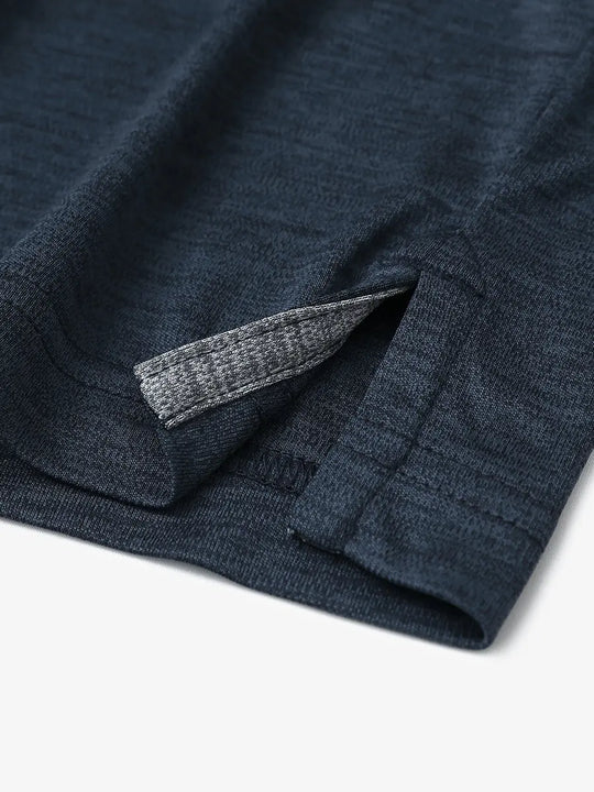 Close-up of hem opening on Modern Fit Melange Polo in NAVY HEATHER, featuring fine stitching and design.