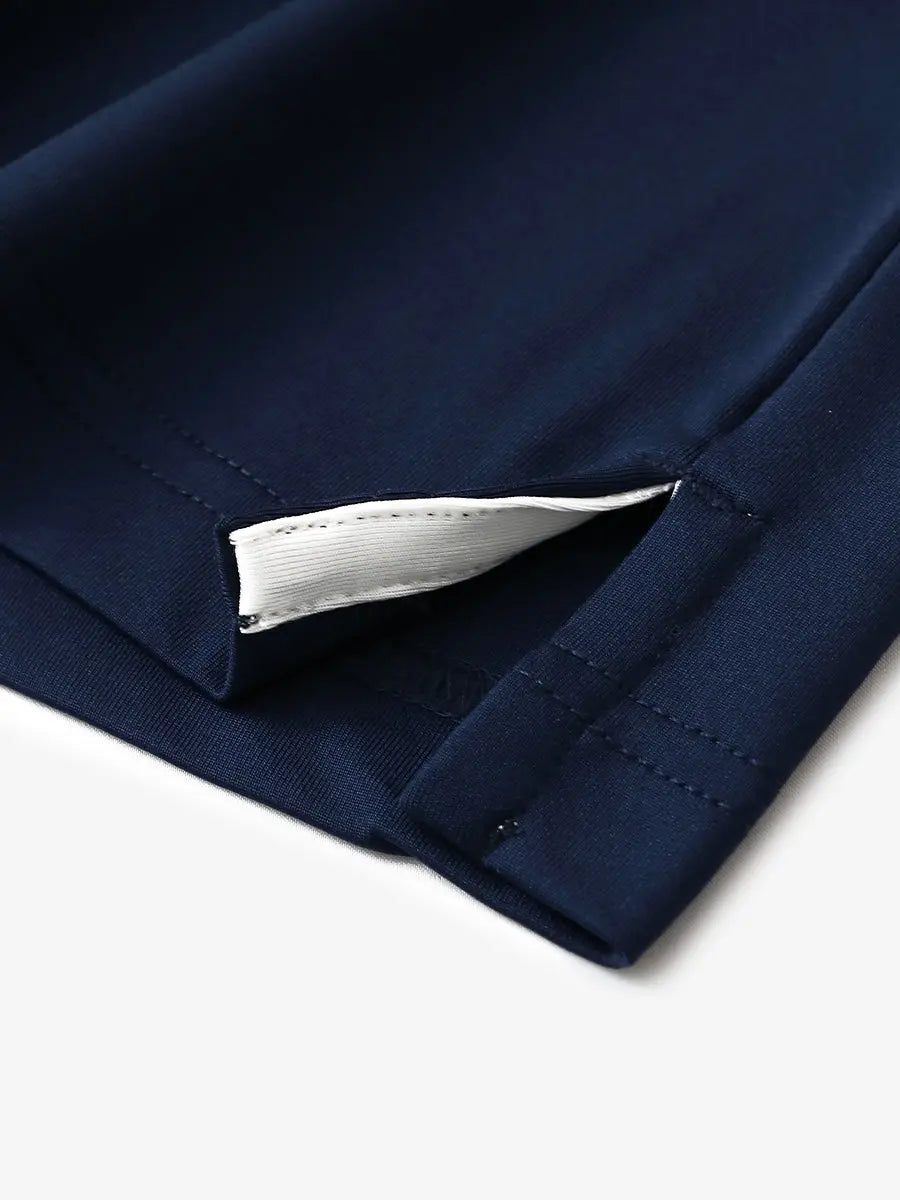 Close-up of hem slit detail in NAVY Premium Performance Polo