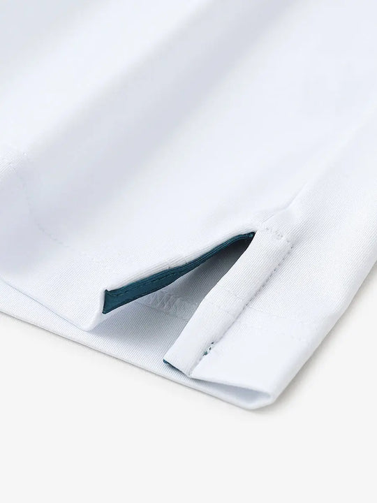 Close-up of hem slit detail in WHITEDUSTY BLUE Premium Performance Polo