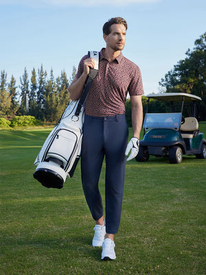 Model walking with golf bag on course in Popular heather print polo, relaxed wine red flower style