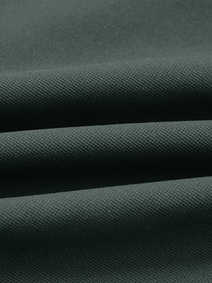 Fabric close-up of lightweight moisture wicking dress pants, showing texture and finish in dark green.